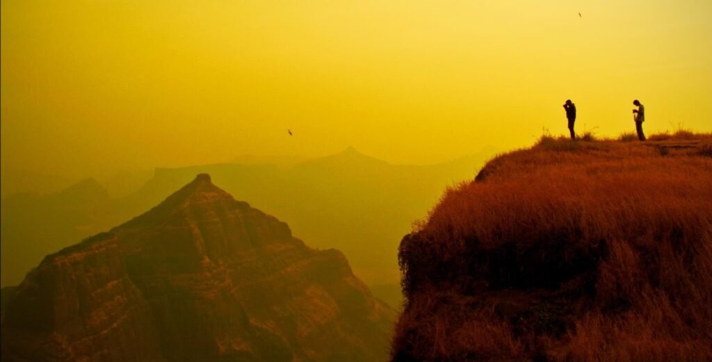 Trekkers taking photos at Konkan Kada on Harishchandragad
